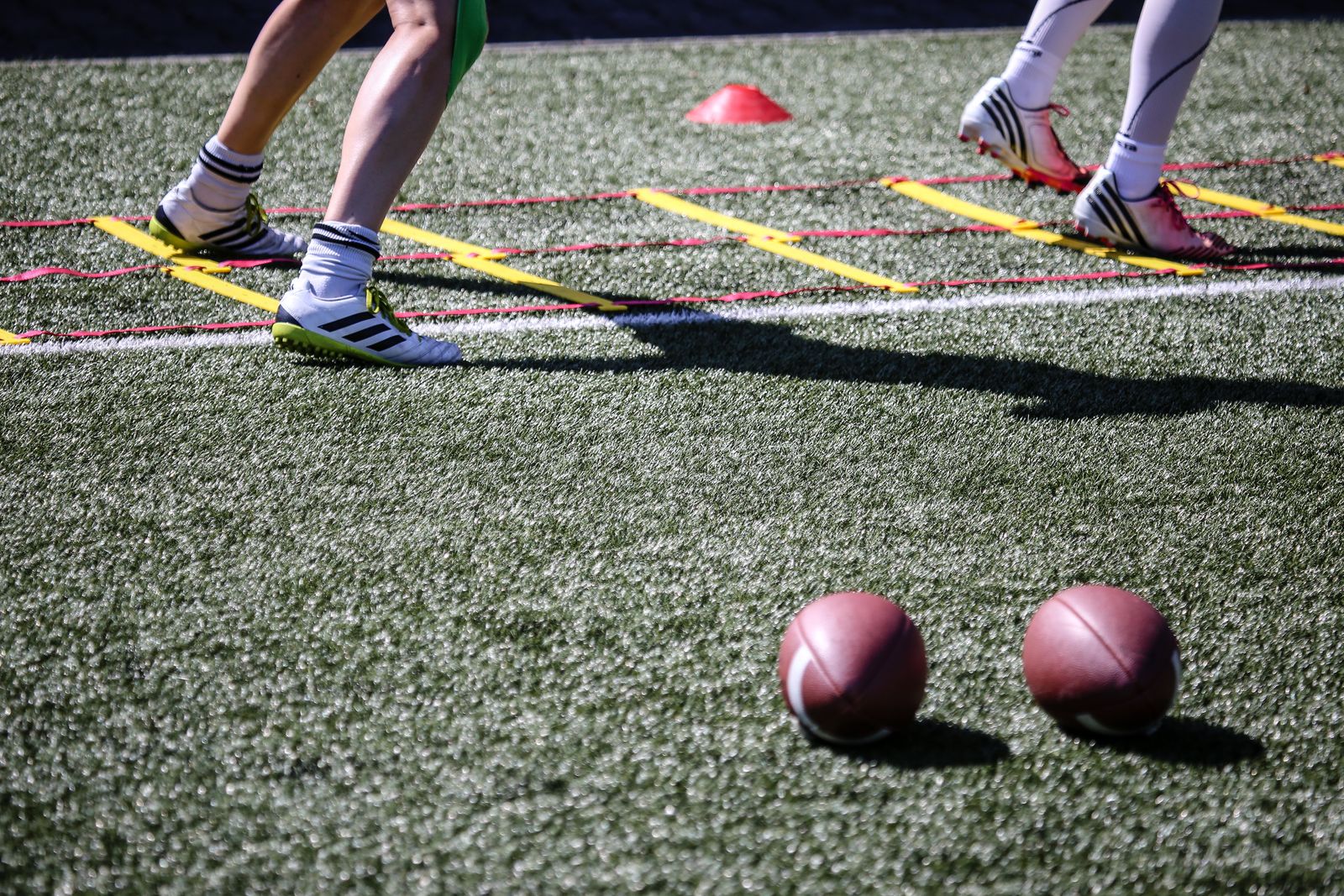 Athletes working through agility drills in a staff-run training session